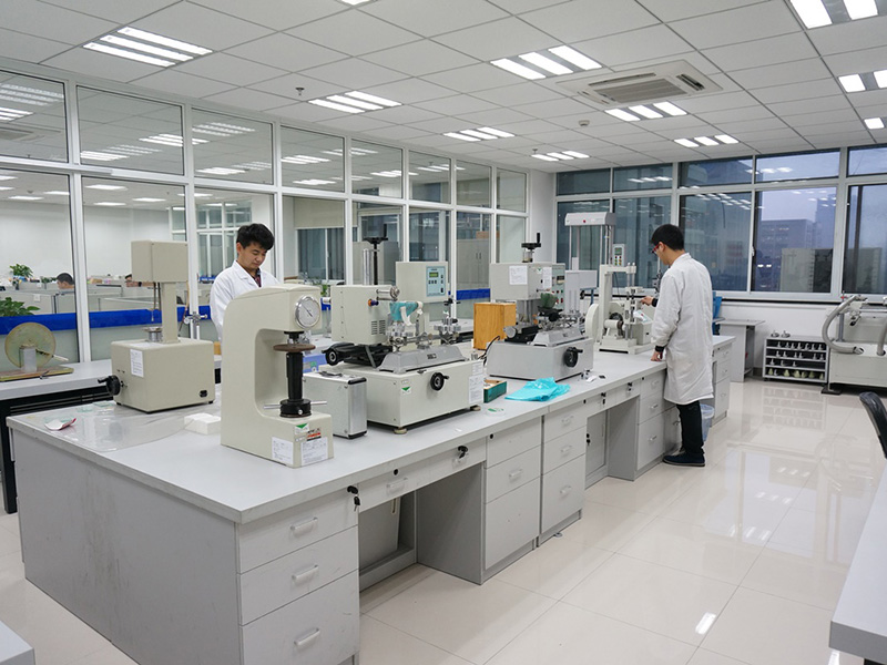 Quality-testing laboratory with technicians and packaging test equipment